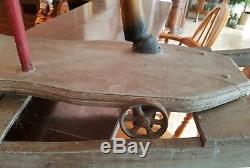 Antique Vtg rocking horse Carved Wood Leather Saddle Cast Iron Wheels Glass Eyes